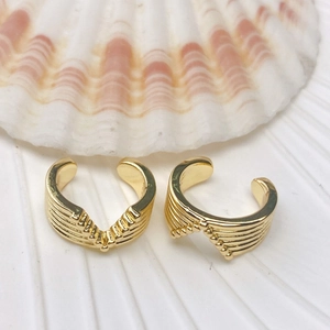 Wave-shaped gold ear cuffs with horizontal texture and tiny bead detailing