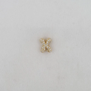 Macro shot of gold-plated balloon letter X pendant with pavé cubic zirconia inlay