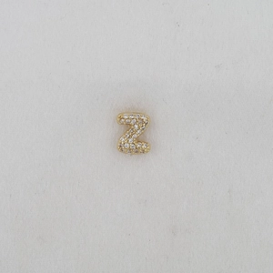 Macro view of gold-plated letter Z pendant with micro-pave cubic zirconia stones