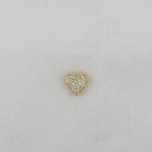 Detailed macro view of a heart-shaped jewelry charm with pavé cubic zirconia inlay