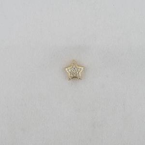 Detail of star-shaped golden charm with pavé-set white cubic zirconia stones