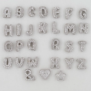 Macro view of 26 alphabet balloon pendants set with sparkling white cubic zirconia