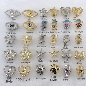 Assorted stainless steel charms in gold and silver with cubic zirconia inlays
