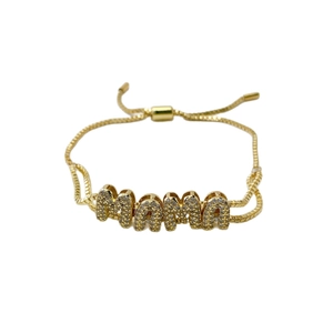 Adjustable golden MAMA bracelet with bubble letter design and shimmering pavé zircon setting