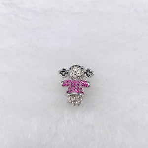 Macro shot of silver cartoon girl charm with pink crystals and micro-pave white stones
