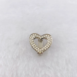 Macro view of heart-shaped stainless steel charm with sparkling pave-set zircons