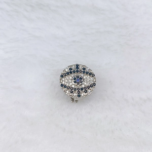 Macro detail of silver evil eye charm with blue cubic zirconia for watch band bracelet