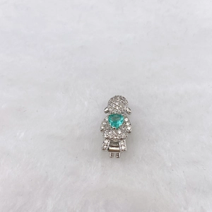 Macro detail of silver girl charm with sparkling green heart zircon for DIY bracelet