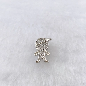 Macro shot of a silver charm featuring a boy figure with sparkling cubic zirconia inlay