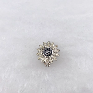 Detailed macro view of a sunflower pendant charm featuring black and white cubic zirconia