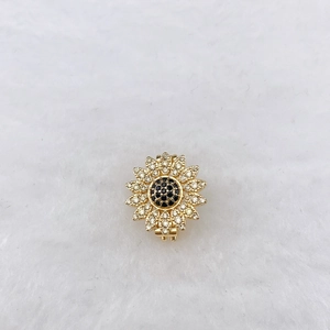 Macro shot of sunflower charm with gold plating and cubic zirconia for stainless steel bracelets