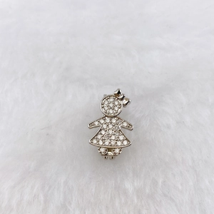 Detailed view of silver girl pendant with shimmering cubic zirconia and bow design