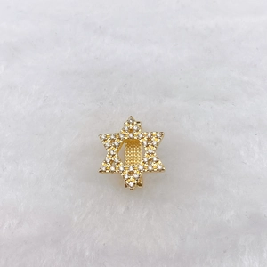 Detailed view of a gold-plated hexagram star charm with shimmering white zircons