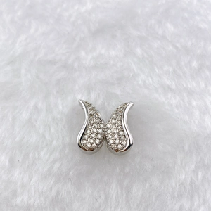 Detailed view of silver butterfly pendant with pavé cubic zirconia on plush background