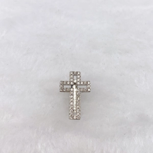 Detailed view of a silver-toned cross charm with sparkling cubic zirconia stones