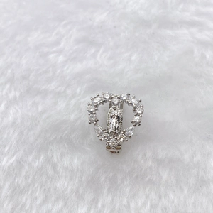 Detail of heart-shaped silver Virgin Mary pendant with sparkling zircon stone setting