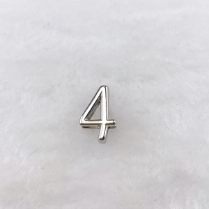 Detailed view of silver number 4 charm accessory for stainless steel strap bracelet