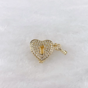 Macro view of gold heart lock and key pendant with pavé sparkling zircon stones