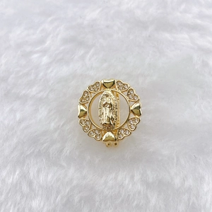 Macro detail of golden Virgin Mary pendant with heart-shaped frame and inlaid zircons