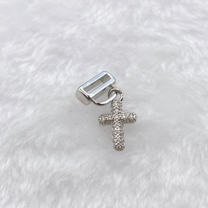 Detailed view of silver cross charm with inlaid zircons on a 10mm wide slider bead