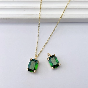 Elegant gold chain necklace with emerald-cut green zircon pendant and stud accents