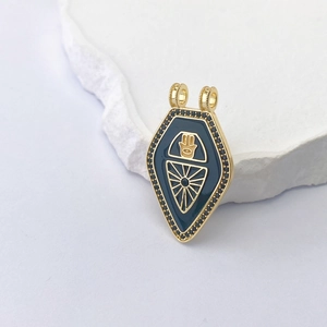 Detailed close-up of golden Hamsa Tarot pendant with blue enamel and black gemstone inlay