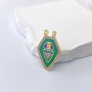 Detail showing the Hamsa Hand tarot pendant with green and purple enamel and zircons