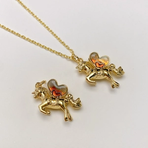 Collar con colgante de unicornio con alas doradas de corazón y resina naranja con purpurina