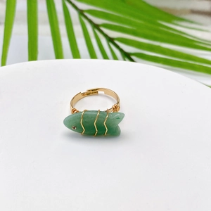 Detailed view of adjustable fish shaped gold ring with green aventurine stone