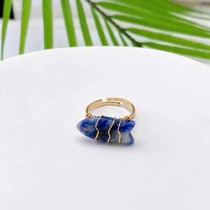 Detailed view of handmade gold wire-wrapped blue fish stone ring with adjustable band