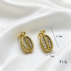 Detailed close-up of golden oval pendant with zircon inlay and 11.5x7mm dimensions