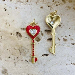 Detailed front and back views of heart-shaped key pendant with red enamel and crystals