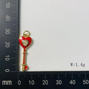 Detail of 1.4g gold-tone heart key pendant with red oil drip and crystal inlay