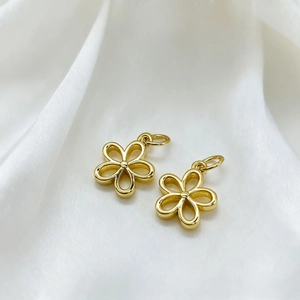 Close-up of 18K gold-plated six-petal flower pendant with polished hollow design