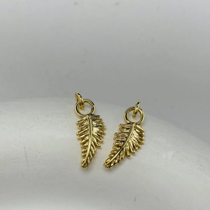 Golden feather leaf charm pendants for DIY jewelry making featuring intricate textures