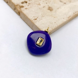 Detailed macro view of square navy blue pendant with yellow gemstone and gold plating