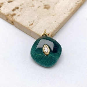 Detail of green malachite pendant with marquise-cut crystal and gold-plated bezel