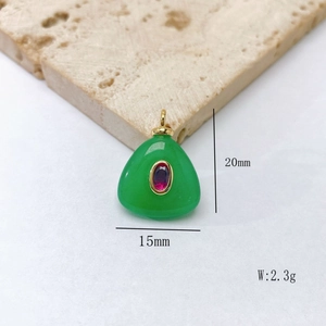 Vue détaillée d'un pendentif en pierre verte avec gemme rouge et dimensions 20x15mm