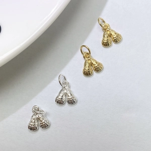 Macro detail of gold and silver textured bell pendants for DIY jewelry accessories