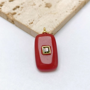 Detail view of retro rectangle red agate pendant with green gemstone and gold frame