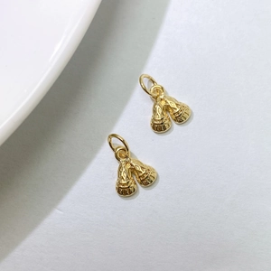 Detail view of gold woven bells pendants for DIY necklace and bracelet accessories