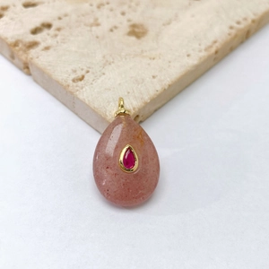 Detail of tear-shaped pink strawberry quartz pendant with gold plated metal clasp