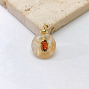 Detailed macro view of a spherical pendant with natural stone and golden metal finish