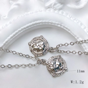 Macro shot of 11mm silver sun relief pendant for DIY necklace with vintage engraving