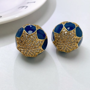 Detail of spherical gold-plated earrings with blue enamel and pave-set zircons