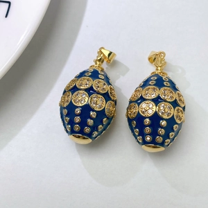 Vintage Faberge style egg pendants with deep blue enamel and gold plating detail