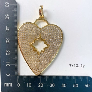 Detailed size measurement of a gold heart pendant with full zircon inlay and star cutout