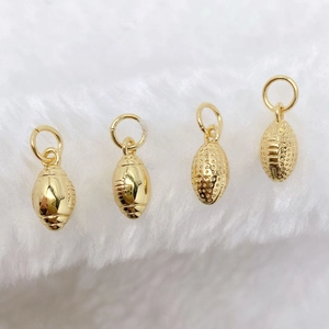 Detail of golden American football pendants in polished and frosted finishes for DIY jewelry