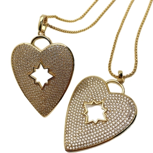 Golden heart pendant necklace with sunburst star cutout and zircon pavé setting