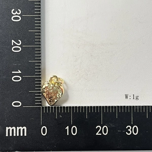 Macro shot of gold strawberry charm showing textured seeds and 10mm scale measurement
